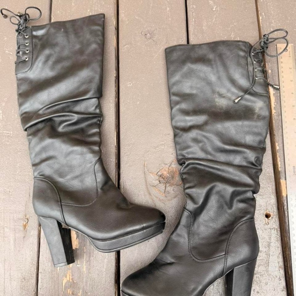Black knee high boots with lace up detail